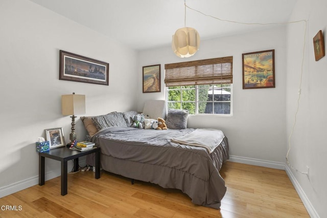 bedroom featuring light wood-type flooring and baseboards