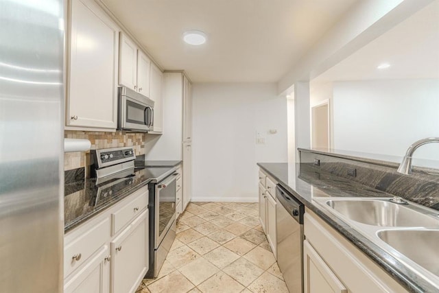 9860 Dale Ave Unit D10, Spring Valley, CA 91977 - kitchen with stainless steel appliances, backsplash, recessed lighting, white cabinets, and dark stone countertops