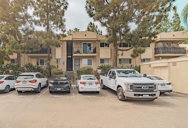 9860 Dale Ave Unit D10, Spring Valley, CA 91977 - view of front of home featuring uncovered parking and stucco siding