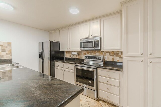 9860 Dale Ave Unit D10, Spring Valley, CA 91977 - kitchen featuring appliances with stainless steel finishes, backsplash, and white cabinets