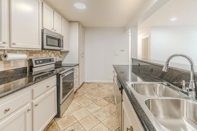 9860 Dale Ave Unit D10, Spring Valley, CA 91977 - kitchen with stainless steel appliances, decorative backsplash, white cabinetry, stone tile flooring, and recessed lighting