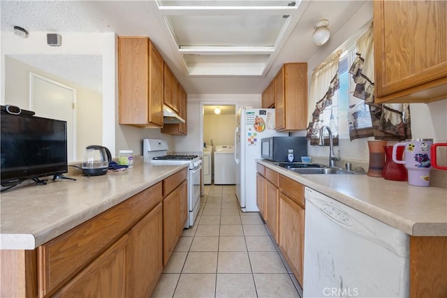 45324 Rodin Ave, Lancaster, CA 93535 - kitchen with under cabinet range hood, white appliances, light tile patterned flooring, a sink, and separate washer and dryer