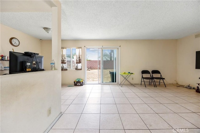 45324 Rodin Ave, Lancaster, CA 93535 - living room with a textured ceiling, visible vents, and light tile patterned flooring