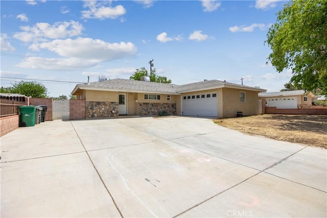 45324 Rodin Ave, Lancaster, CA 93535 - single story home featuring fence, an attached garage, stone siding, concrete driveway, and stucco siding