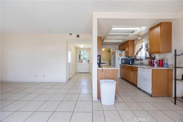 45324 Rodin Ave, Lancaster, CA 93535 - kitchen featuring light countertops, plenty of natural light, light tile patterned flooring, and white appliances