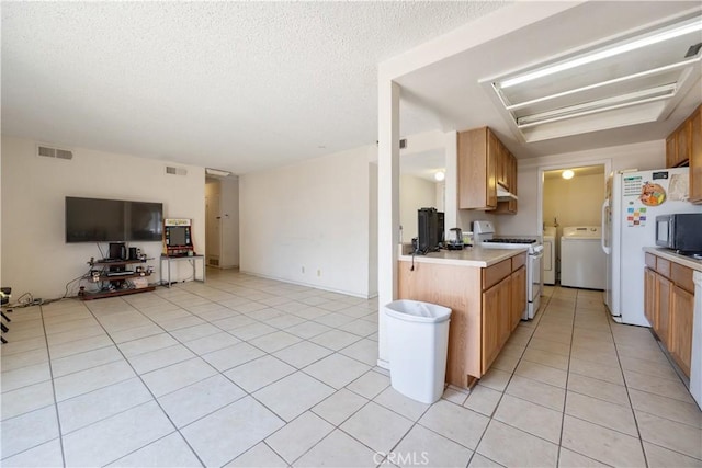 45324 Rodin Ave, Lancaster, CA 93535 - kitchen with light tile patterned floors, open floor plan, visible vents, white appliances, and light countertops