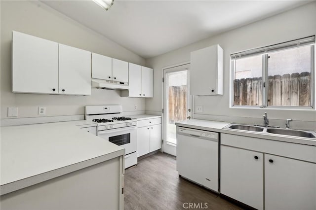 kitchen featuring lofted ceiling, under cabinet range hood, white appliances, a sink, and light countertops