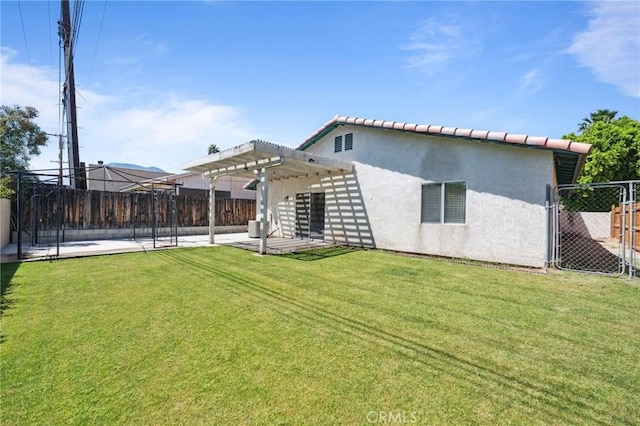 back of property with a yard, a patio, stucco siding, a pergola, and a fenced backyard
