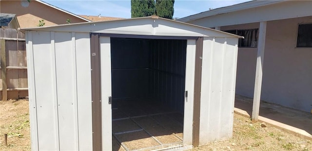 view of shed featuring fence