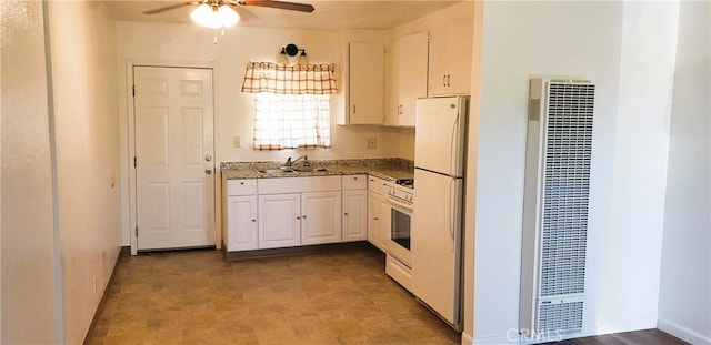 kitchen featuring a ceiling fan, a sink, a heating unit, white cabinetry, and white appliances