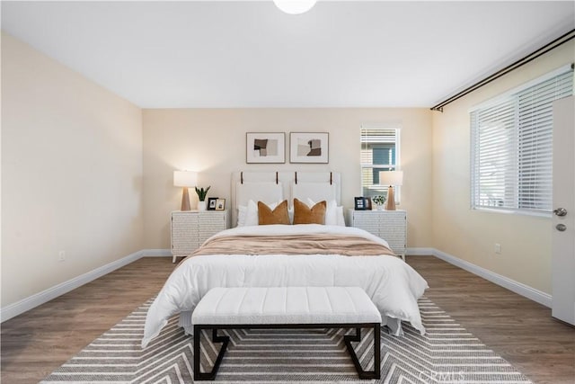 bedroom featuring baseboards and wood finished floors