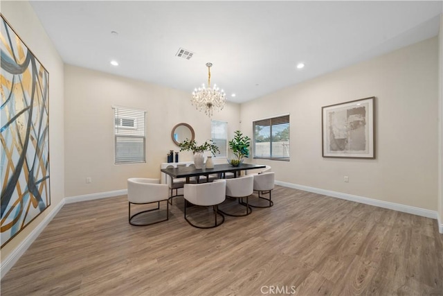 dining space with baseboards and wood finished floors