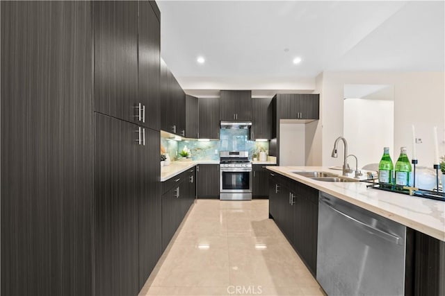 kitchen with light tile patterned floors, modern cabinets, stainless steel appliances, and a sink