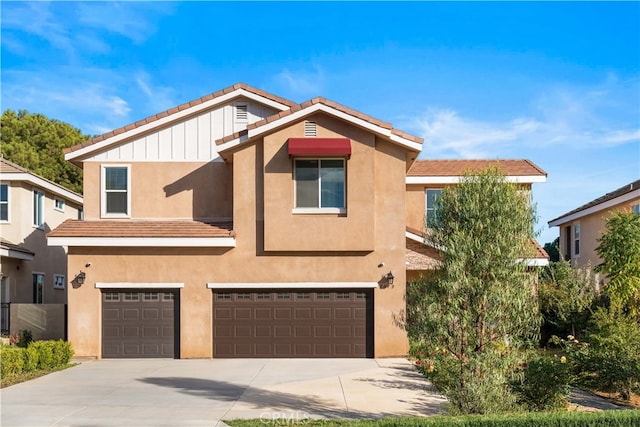 multi unit property featuring driveway, stucco siding, an attached garage, and board and batten siding