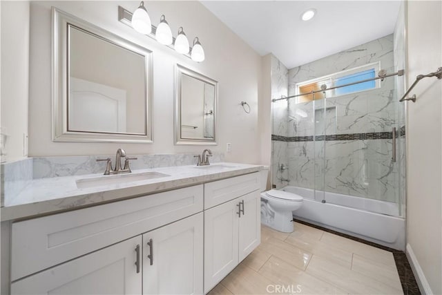full bathroom featuring a sink, double vanity, toilet, and enclosed tub / shower combo
