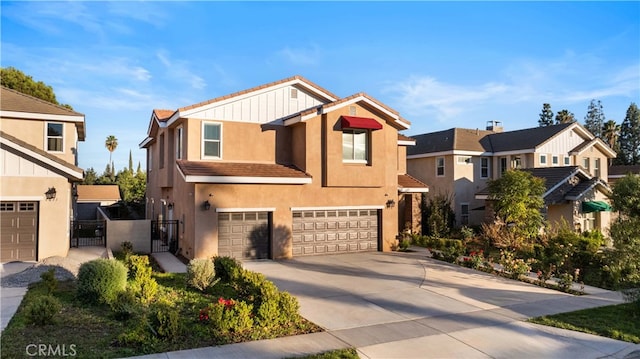 view of front of home featuring a gate, an attached garage, a residential view, concrete driveway, and stucco siding