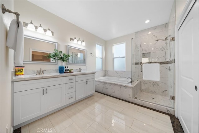 bathroom with a sink, double vanity, a marble finish shower, and a garden tub