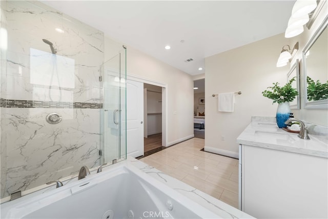 bathroom with double vanity, a marble finish shower, a sink, a tub with jets, and baseboards