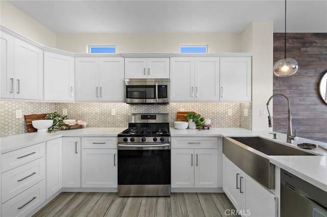 2852 N Santa Fe Pl, Orange, CA 92865 - kitchen with white cabinetry, appliances with stainless steel finishes, light wood-style flooring, and a sink
