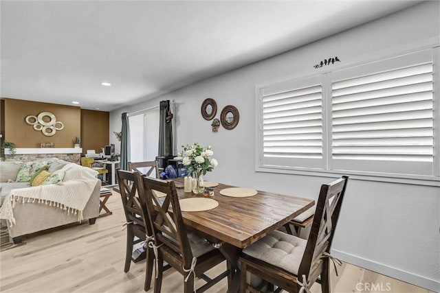 dining room with light wood finished floors and recessed lighting