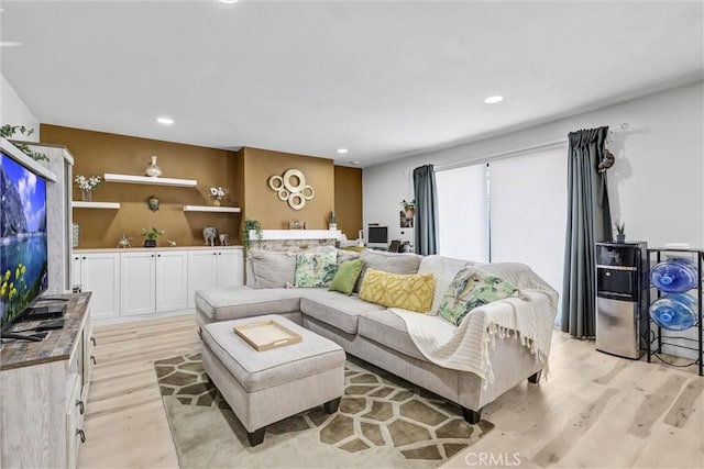 living area featuring light wood-style flooring and recessed lighting