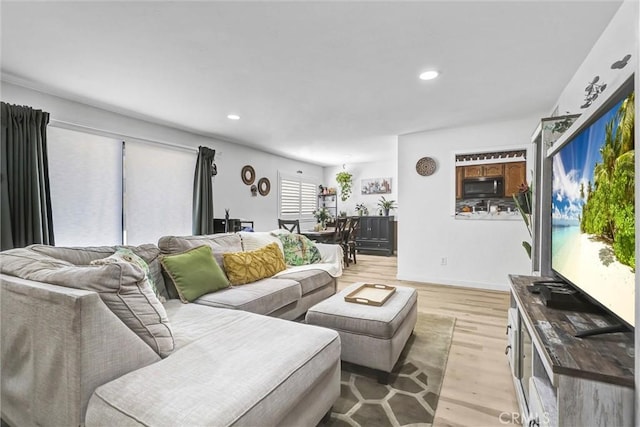 living room featuring light wood-style flooring and recessed lighting