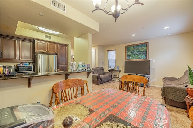 12229 Inspire Ln, Pacoima, CA 91331 - dining space featuring a chandelier, recessed lighting, light tile patterned floors, and baseboards