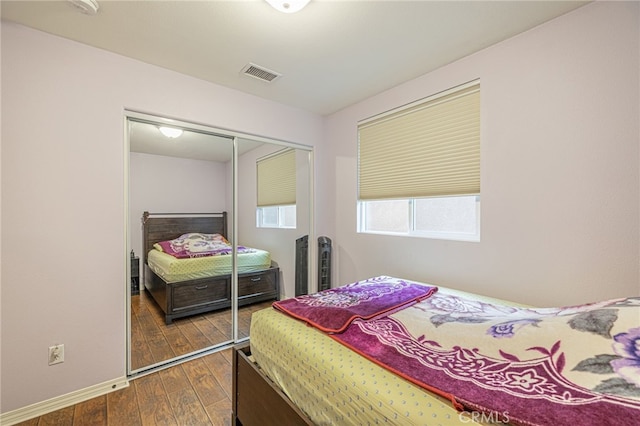 12229 Inspire Ln, Pacoima, CA 91331 - bedroom with a closet, dark wood-style flooring, and baseboards
