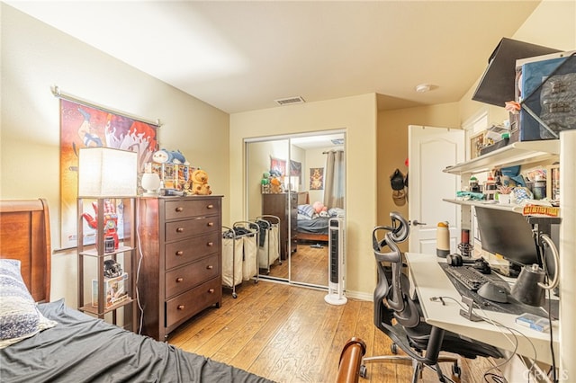 12229 Inspire Ln, Pacoima, CA 91331 - bedroom featuring light wood-style flooring, a closet, a desk, and baseboards