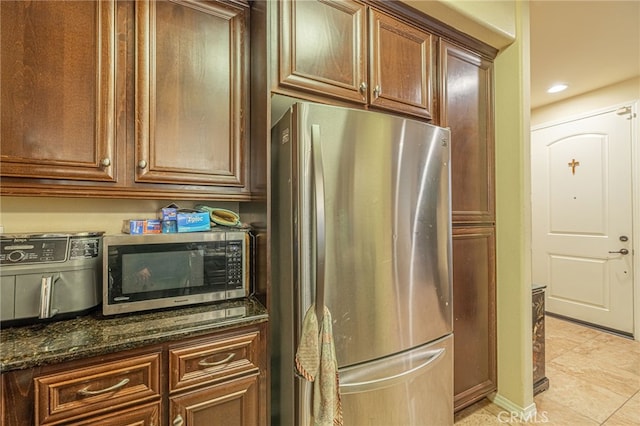12229 Inspire Ln, Pacoima, CA 91331 - kitchen featuring appliances with stainless steel finishes, light tile patterned floors, recessed lighting, and dark stone counters