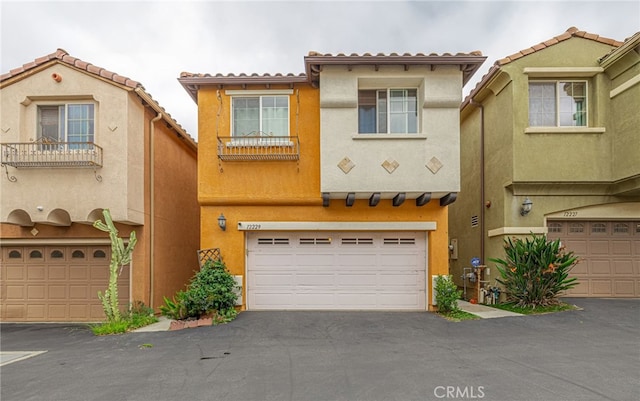 12229 Inspire Ln, Pacoima, CA 91331 - view of front of home with a garage, stucco siding, asphalt driveway, and a tile roof