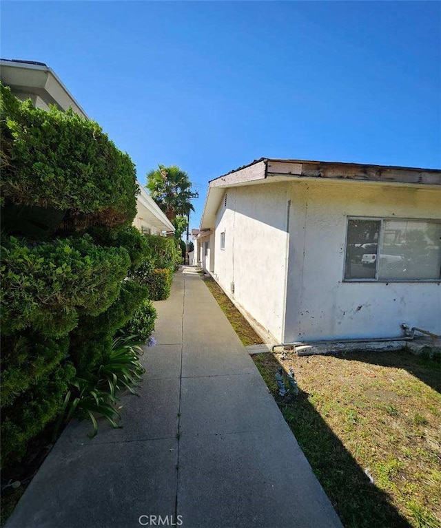 view of property exterior featuring stucco siding and a patio