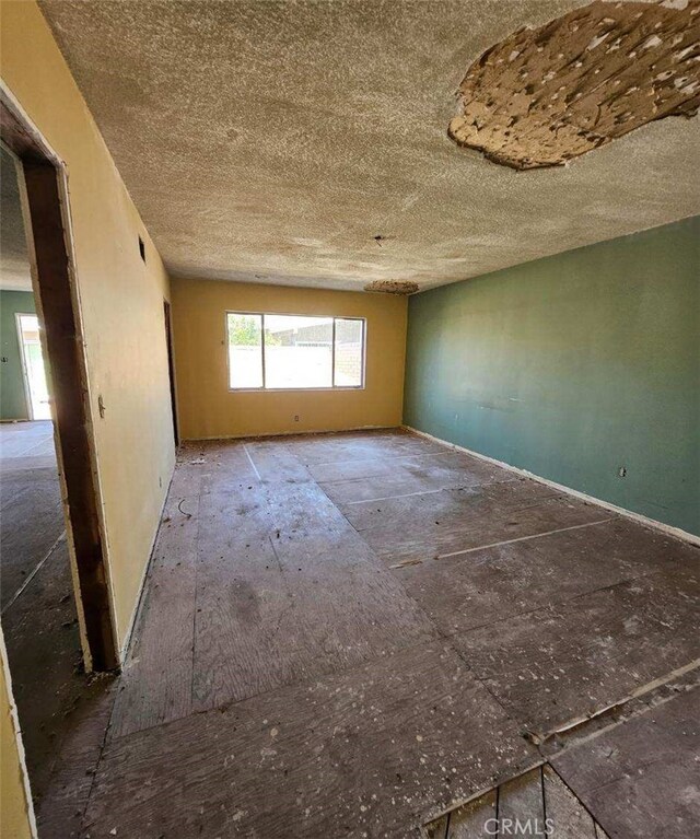 unfurnished room featuring a textured ceiling