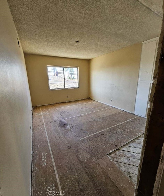 empty room featuring a textured ceiling