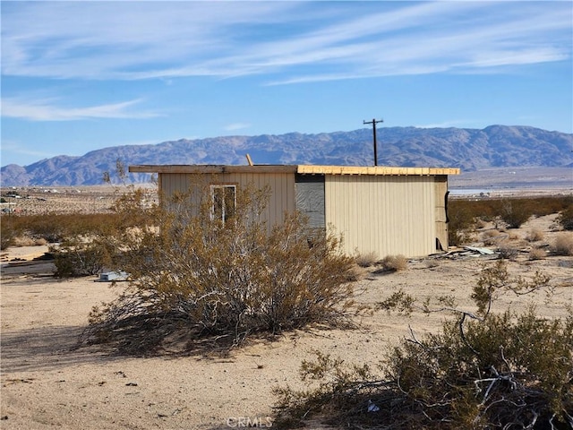 view of outbuilding with a mountain view and an outdoor structure