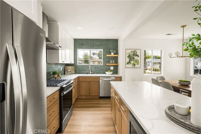 6655 Balcom Ave, Reseda, CA 91335 - kitchen with light wood-type flooring, a wealth of natural light, tasteful backsplash, and appliances with stainless steel finishes