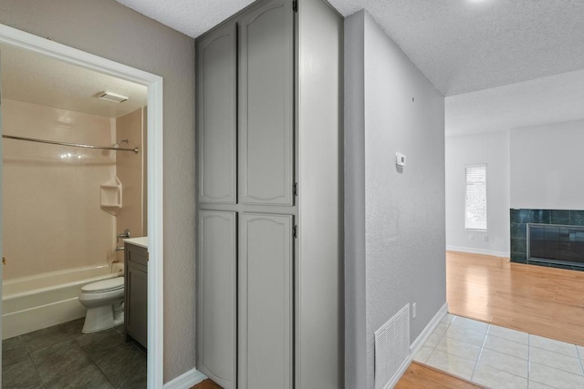 992 Lupine Hills Dr Unit 98, Vista, CA 92081 - corridor featuring baseboards, tile patterned floors, visible vents, and a textured ceiling