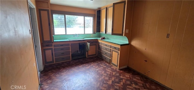 unfurnished office with built in desk and wood walls