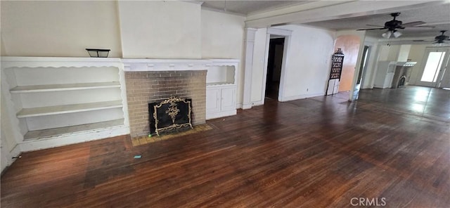 unfurnished living room featuring a ceiling fan, a fireplace, and wood finished floors