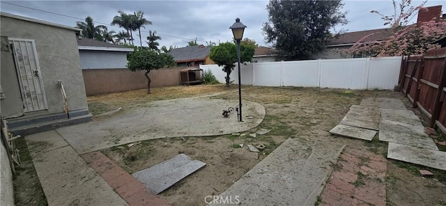 view of yard with a patio area and a fenced backyard