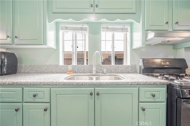 4253 Eugene St, Los Angeles, CA 90063 - kitchen with black gas range oven, a sink, light stone countertops, green cabinets, and under cabinet range hood