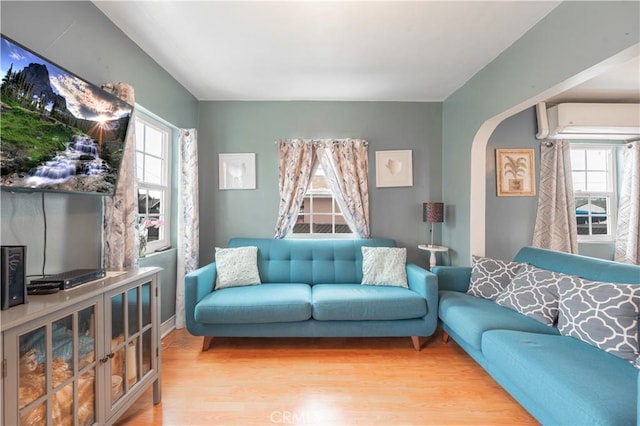 4253 Eugene St, Los Angeles, CA 90063 - living area with arched walkways, light wood-style flooring, and a wall unit AC