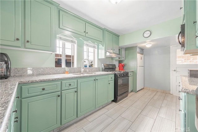 4253 Eugene St, Los Angeles, CA 90063 - kitchen with freestanding refrigerator, under cabinet range hood, green cabinets, a sink, and black gas stove