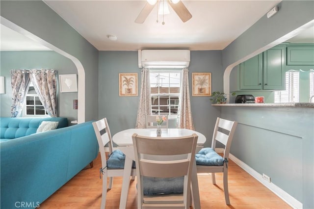 4253 Eugene St, Los Angeles, CA 90063 - dining space featuring a wall mounted air conditioner, light wood-type flooring, baseboards, and ceiling fan