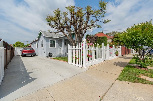 4253 Eugene St, Los Angeles, CA 90063 - view of front of house with driveway, stucco siding, and a fenced front yard