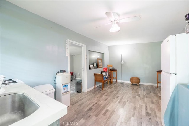 4253 Eugene St, Los Angeles, CA 90063 - interior space with baseboards, light wood-style flooring, a ceiling fan, and a sink