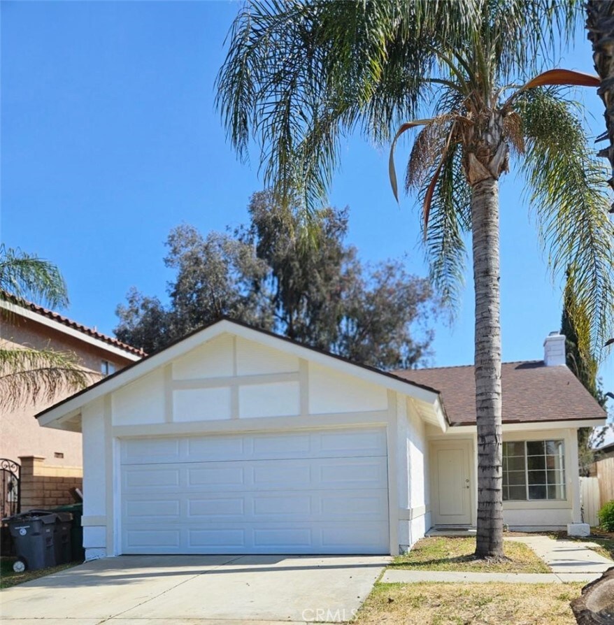 ranch-style home featuring a garage, stucco siding, fence, concrete driveway, and a shingled roof
