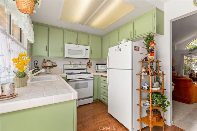 672 La Quinta Dr, Banning, CA 92220 - kitchen featuring tile countertops, a toaster, white appliances, a sink, and light wood-style floors