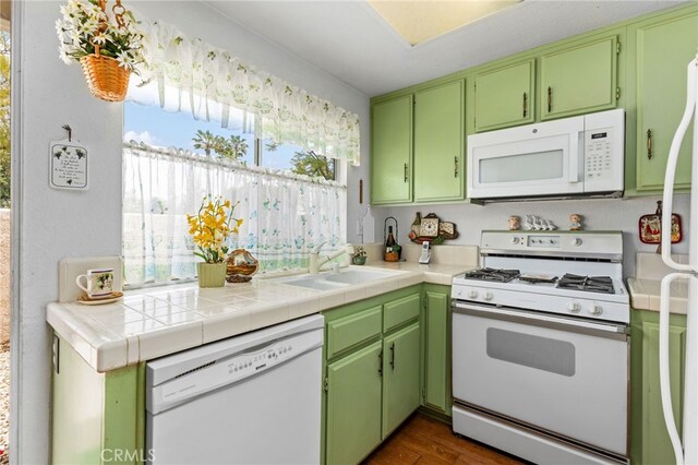 672 La Quinta Dr, Banning, CA 92220 - kitchen featuring white appliances, light countertops, a sink, and dark wood-type flooring