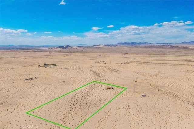 birds eye view of property featuring a mountain view, a desert view, and a rural view